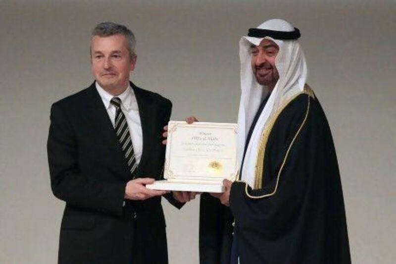 Sheikh Mohammed bin Zayed, Crown Prince of Abu Dhabi and Deputy Supreme Commander of the Armed Forces, presents the Zayed Future Energy Prize to Paul Dickinson, the founder of the Carbon Disclosure Project. Ravindranath K / The National