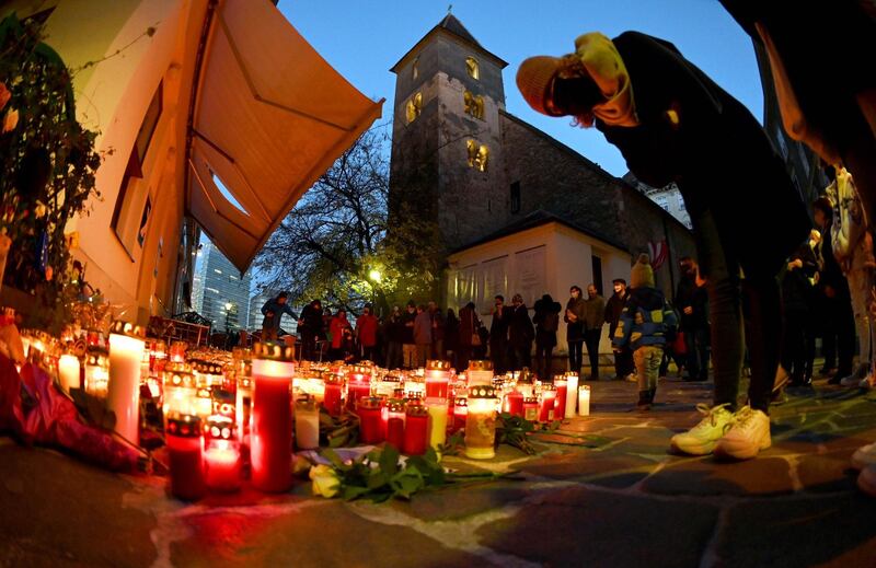 Inhabitants light candles as they pay tribute to the victims of the attack at one of the crime scenes in front of Saint Rupert's Church in the city centre of Vienna on November 7, 2020. The Austrian government ordered the closure on November 6 of two mosques in the capital Vienna frequented by the jihadist gunman who shot dead four people in the city centre earlier in the week. The shooting on November 2 was Austria's first major attack in decades and its first blamed on a jihadist, identified as 20-year-old Kujtim Fejzulai, who was killed by police. - Austria OUT
 / AFP / APA / BARBARA GINDL
