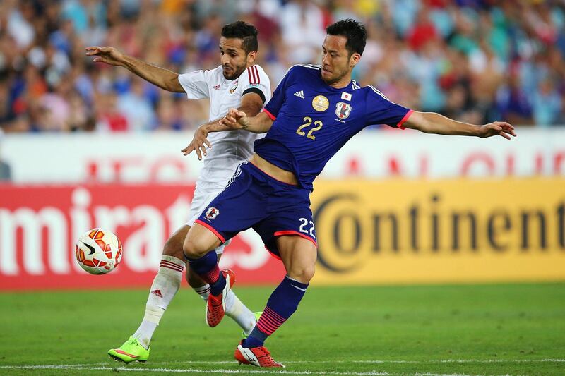 SYDNEY, AUSTRALIA - JANUARY 23:  Maya Yoshida of Japan competes with Ali Mabkhout of the United Arab Emirates during the 2015 Asian Cup Quarter Final match between Japan and the United Arab Emirates at ANZ Stadium on January 23, 2015 in Sydney, Australia.  (Photo by Brendon Thorne/Getty Images)