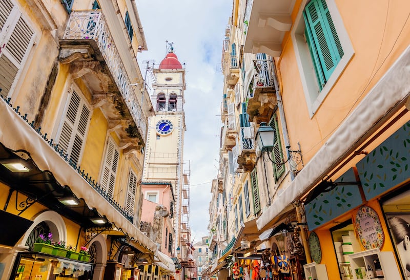 A narrow shopping street with a view of the Saint Spyridon Church bell tower in Corfu town, Greece. Getty Images