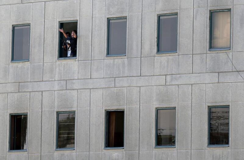 Armed men gesture out of the window. Omid Wahabzadeh / EPA