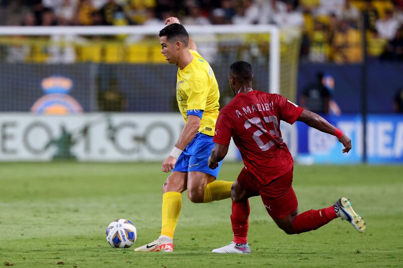 Cristiano Ronaldo on the ball under pressure from Duhail midfielder Assim Madibo. AFP