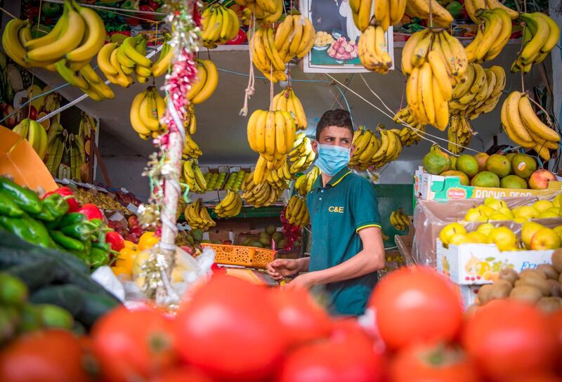 A vendor, wearing a protective mask, waits for costumers at the central market in the Moroccan capital Rabat. AFP