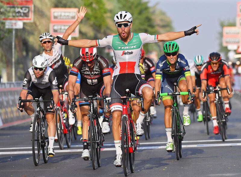 Italian rider Giacomo Nizzolo, centre of Trek-Segafredo, celebrates after crossing the finish line to win Stage 1 of the Abu Dhabi Tour cycling race over 147km in Madinat Zayed, Abu Dhabi, UAE, on Thursday, October 20, 2016. Luca Zennaro / EPA