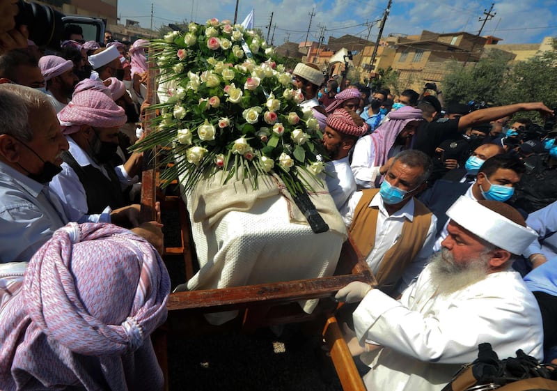 Iraqi Yazidi men surround the casket of Baba Sheikh Khurto Hajji Ismail during his funeral procession in the Iraqi town of Sheikhan. AFP
