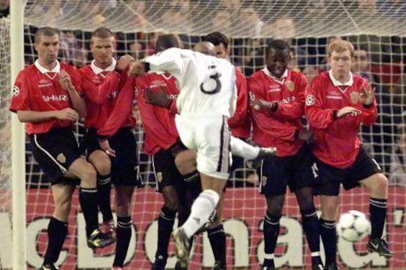 Real Madrid's Roberto Carlos tries to shoot past Manchester United defenders (from left, Roy Keane, David Beckham, Andrew Cole, Ryan Giggs, Dwight Yorke and Paul Scholes) in 2002.