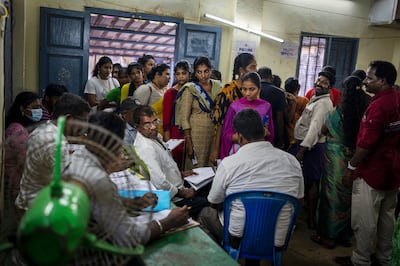 People crowd a booth to vote, shortly before the end of voting, during the first round of polling in Chennai, southern Tamil Nadu state. AP