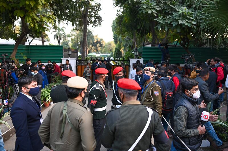 Security and media personnel outside the entrance to Gen Bipin Rawat's house in New Delhi on December 8, 2021. AFP
