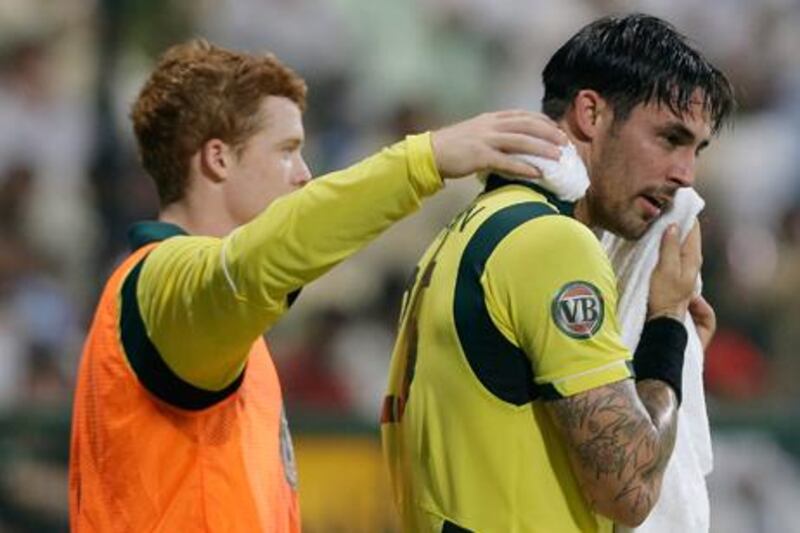 Australian cricketer Mitchell Johnson tries off with a cold towel during the ODI in Abu Dhabi.