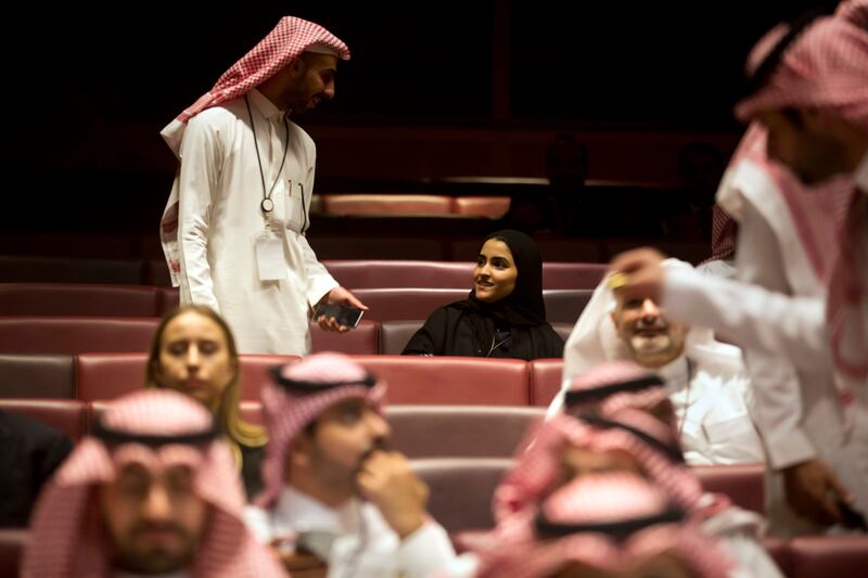 Vsitors wait for the movie to begin during an invitation-only screening, at the King Abdullah Financial District Theater, in Riyadh, Saudi Arabia, Wednesday, April 18, 2018. Saudi Arabia held a private screening of the Hollywood blockbuster "Black Panther" Wednesday, to herald the launch of movie theaters that are set to open to the public next month. (AP Photo/Amr Nabil)