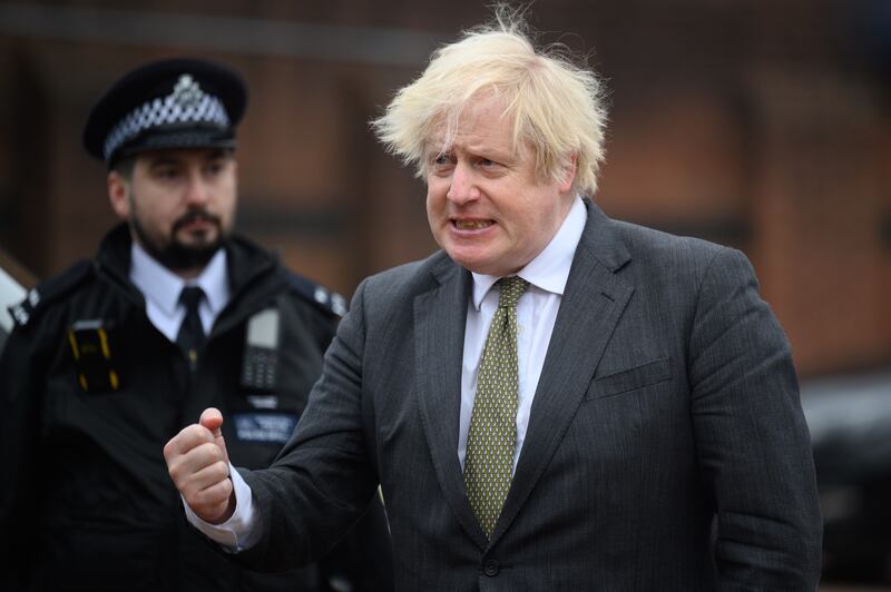 Mr Johnson speaks with officers as he makes a constituency visit to Uxbridge police station in December 2021. Getty Images