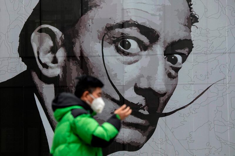 A man wearing a protective facemask walks in a shopping mall in Shanghai.  AFP