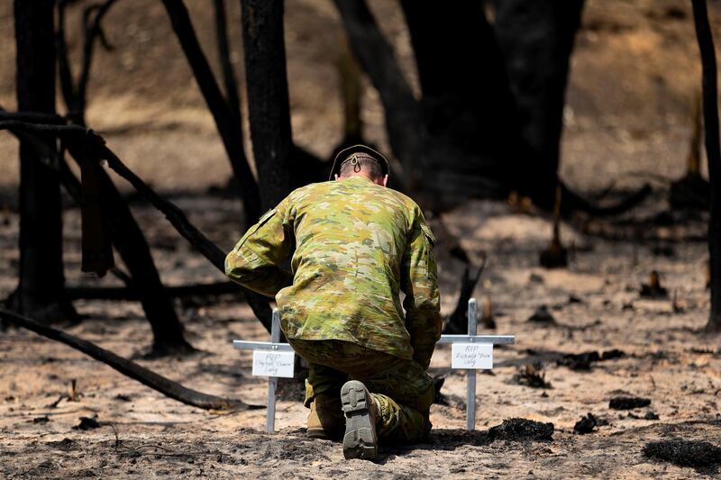 Lieutenant Kynan Lang from the 10th/27th Battalion visits the scene where his uncle and cousin died in a bushfire to place a memorial on Kangaroo Island, Australia.  Reuters