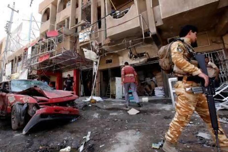 An Iraqi soldier inspects the scene of a car bomb attack in the Sha'ab neighborhood of Baghdad.
