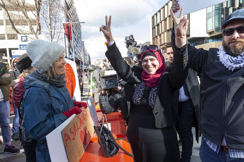 Survivors of a deadly mosque shooting celebrate with supporters after Brenton Tarrant was sentenced to life in prison, outside the High Court in Christchurch, New Zealand.  EPA