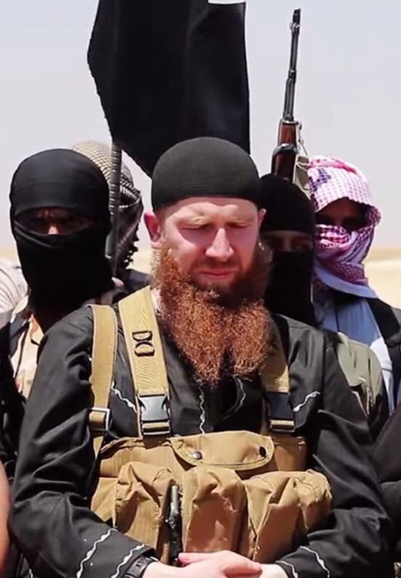 Members of Isis including military leader and Georgian native, Abu Omar Al Shishani, centre, speaking at an unknown location between the Iraqi Nineveh province and the Syrian town of Al Hasakah. AFP