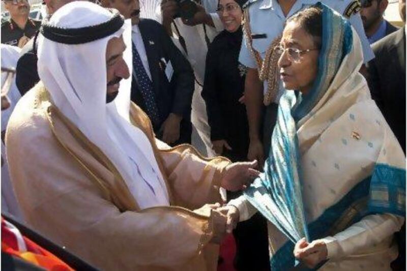Sheikh Sultan bin Mohammed, the Ruler of Sharjah, greets India's president, Pratibha Patil, as she arrives at the Indian Trade Exhibition Centre yesterday.