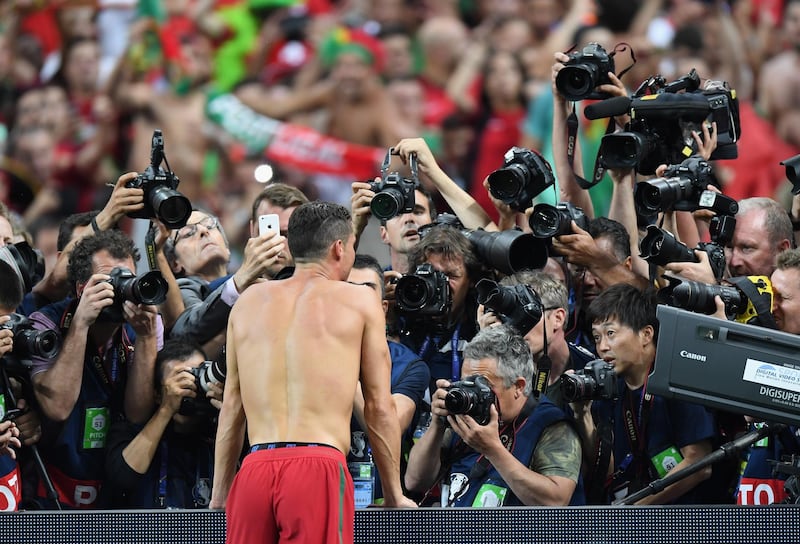 PARIS, FRANCE - JULY 10:  Cristiano Ronaldo of Portugal is centre of media attention as he celebrates winning at the final whistle during the UEFA EURO 2016 Final match between Portugal and France at Stade de France on July 10, 2016 in Paris, France.  (Photo by Michael Regan/Getty Images)