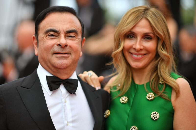 (FILES) This file photo taken on May 26, 2017 shows Renault CEO Carlos Ghosn (L) and his wife Carole Ghosn arriving for the screening of the film 'L'Amant Double' (Amant Double) at the 70th edition of the Cannes Film Festival in Cannes. In a letter to Human Rights Watch received by AFP on January 14, 2019, Carole Ghosn, the wife of ex-Nissan chief Carlos Ghosn, has alleged her husband is being held in "harsh" conditions and subjected to round-the-clock interrogations intended to extract a confession. / AFP / LOIC VENANCE
