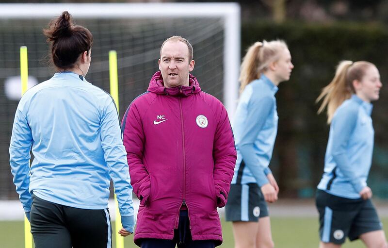 Manchester City Women manager Nick Cushing talks with Jennifer Beattie, during a training session at the City Football Academy, Manchester.