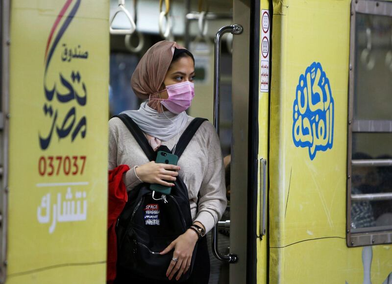A woman wearing a protective face mask is seen inside the underground Al Shohadaa "Martyrs" metro while Egypt ramps up its efforts to slow down the spread of the coronavirus. Reuters