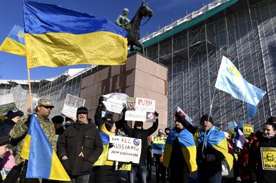 Demonstrators in Helsinki, Finland, wave Ukrainian flags during a We Stand With Ukraine demonstration. AFP