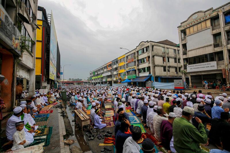 Rohingya Muslims pray on a street during Eid Al Adha celebrations in Kuala Lumpur, Malaysia.  EPA