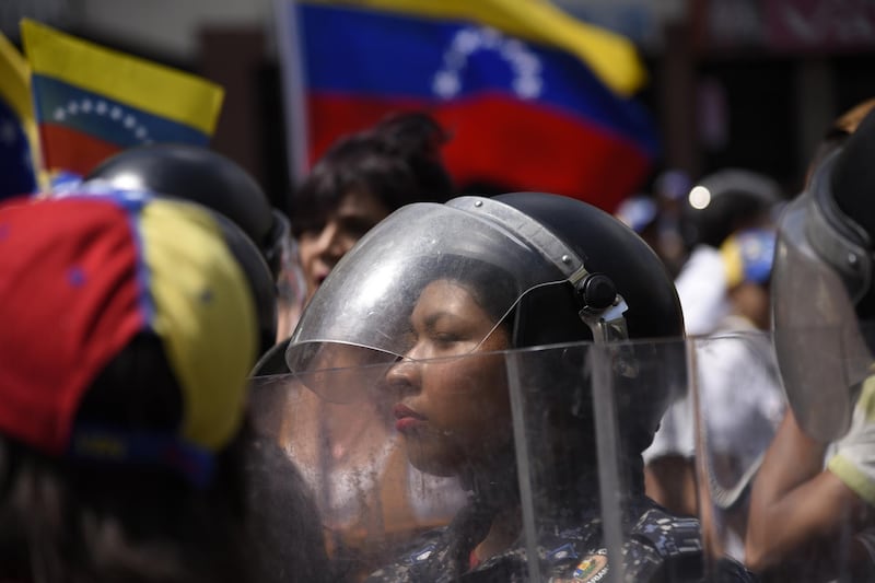 Bolivarian National Police officers stand in formation during an anti-government protest in Caracas, Venezuela. Bloomberg