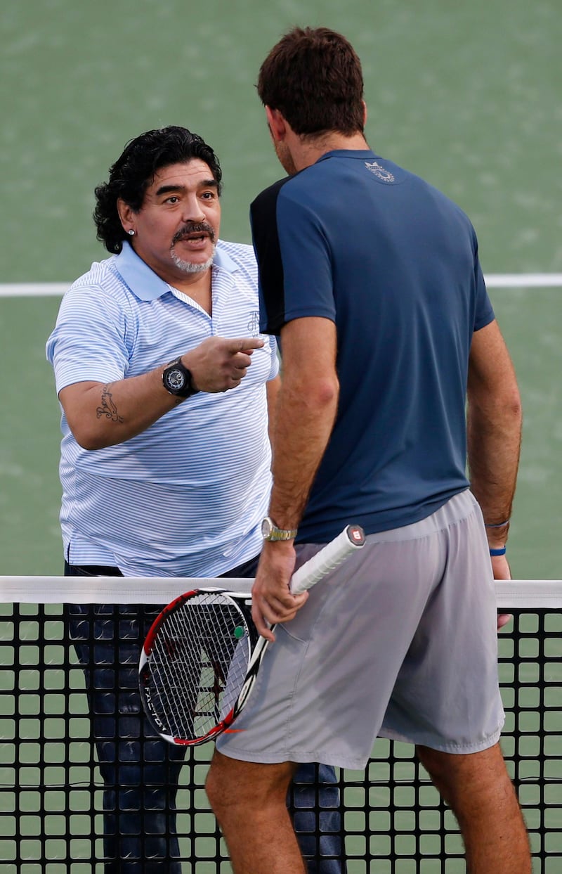 Juan Martin Del Potro of Argentina speaks to former Argentine soccer star Diego Maradona after his men's singles match against Somdev Devvarman of India during the ATP Dubai Tennis Championships, February 27, 2013. REUTERS/Mohammed Salem (UNITED ARAB EMIRATES - Tags: SPORT TENNIS ENTERTAINMENT) *** Local Caption ***  DUB13_TENNIS-MEN-DU_0227_11.JPG