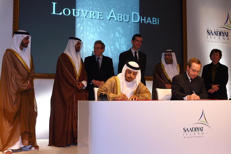 French Culture Minister Renaud Donnedieu de Vabres (bottom R) and the head of Abu Dhabi Tourism Authority, Sheikh Sultan bin Tahnun al-Nahayan (bottom L) sign a controversial agreement to build an annex of Paris' famed Louvre art gallery in Abu Dhabi, 06 March 2007.  Under the 30-year agreement, the government of Abu Dhabi, capital of the UAE, will pay 400 million euros (525 million dollars) just for the Louvre name, of which 150 million euros will be paid within a month. AFP PHOTO/THOMAS COEX (Photo by THOMAS COEX / AFP)