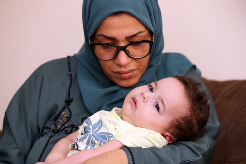 Saif Ismael with his mother Hayat Mabda. Saif suffers from spinal muscular atrophy. The National