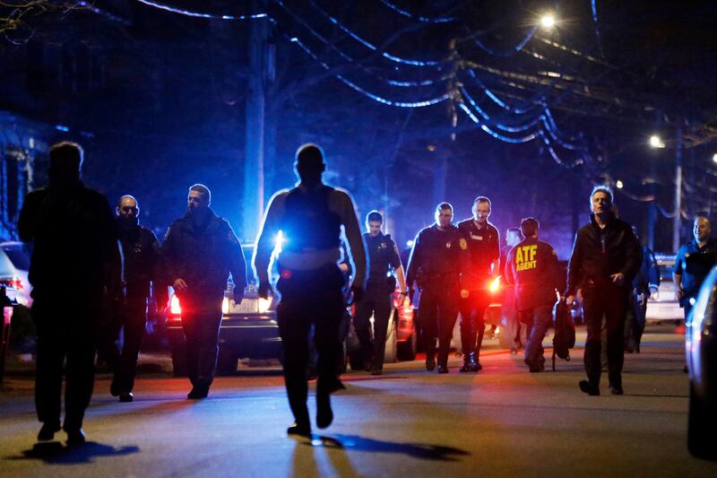 Police officers walk near a crime scene Friday, April 19, 2013, in Watertown, Mass. A tense night of police activity that left a university officer dead on campus just days after the Boston Marathon bombings and amid a hunt for two suspects caused officers to converge on a neighborhood outside Boston, where residents heard gunfire and explosions.(AP Photo/Matt Rourke) *** Local Caption ***  APTOPIX Police Converge Mass.JPEG-00bbb.jpg