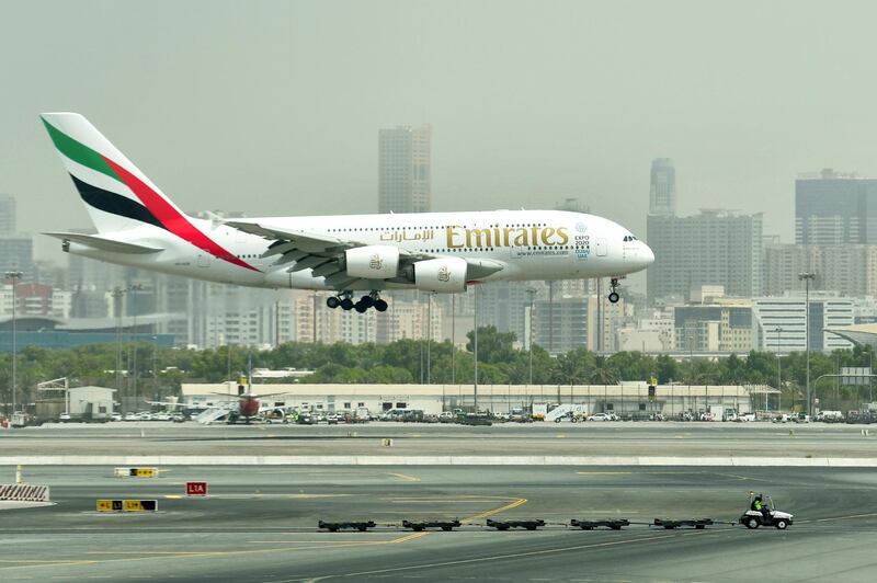 A picture take on September 14, 2017 shows an Airbus A380 of Emirates landing at the tarmac at Dubai's International Airport.
 / AFP PHOTO / GIUSEPPE CACACE