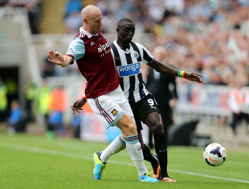 West Ham United's James Collins, left, vies for the ball with Newcastle United's Papiss Cisse, right, during their English Premier League soccer match at St James' Park, Newcastle, England, Saturday, Aug. 24, 2013. (AP Photo/Scott Heppell) *** Local Caption ***  Britain Soccer Premier League.JPEG-04a69.jpg