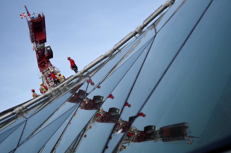 A crane is reflected on the glass facade of the Jewel Changi Airport in Singapore. Feline Lim / Reuters