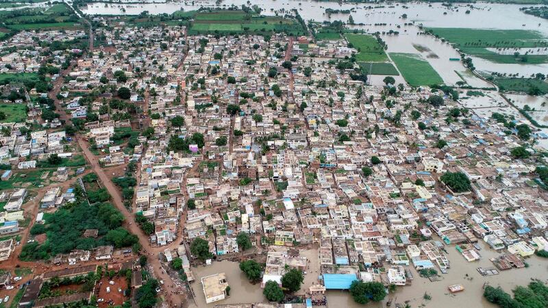An aerial view of Kamtagi village submerged in floodwaters in Bagalkot district in Karnataka about 460 kms of the South Indian city of Bangalore on August 10, 2019. Floods have killed at least 100 people and displaced hundreds of thousands across much of India with the southern state of Kerala worst hit, authorities said on August 10. / AFP / STR
