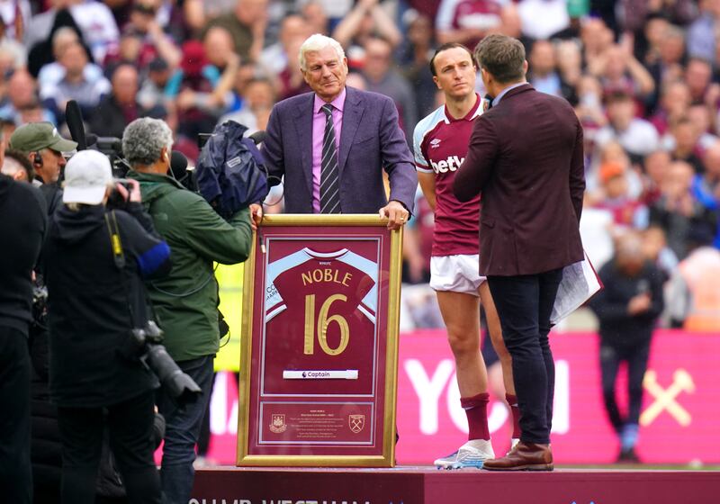 Former West Ham player Trevor Brooking presents Mark Noble with a framed shirt to mark his last home game for the club. PA