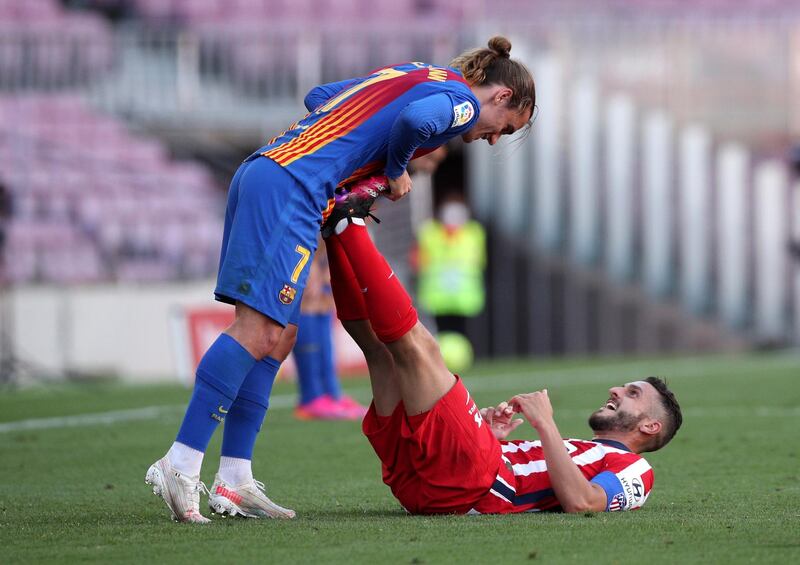 Barcelona's Antoine Griezmann with Koke of Atletico Madrid. Reuters