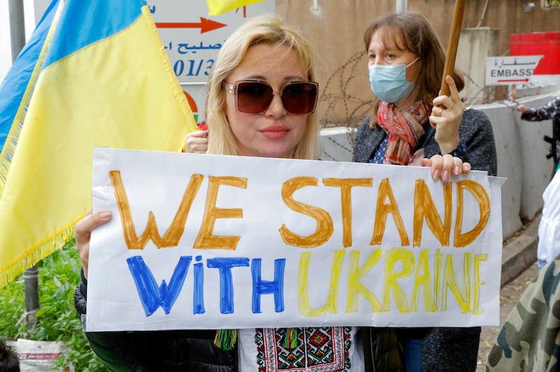 A Ukrainian woman carries a placard. EPA