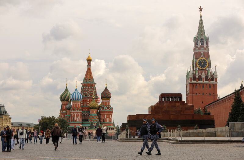 People walk across Red Square by the Kremlin and St Basil's Cathedral in Moscow. Reuters