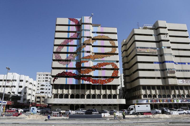 eL Seed’s first public artwork for the UAE covers the wall of an abandoned building in Sharjah. Sarah Dea / The National