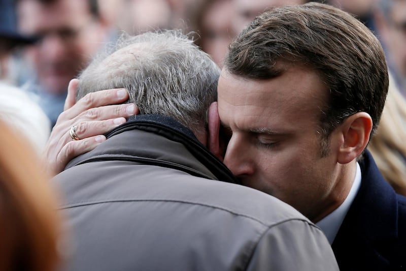 French President Emmanuel Macron gives his condolences to relatives of victims near the Bataclan concert venue during a ceremony marking the second anniversary of the Paris attacks of November 2015 in which 130 people were killed, in Paris, France, November 13, 2017.   REUTERS/Etienne Laurent/Pool