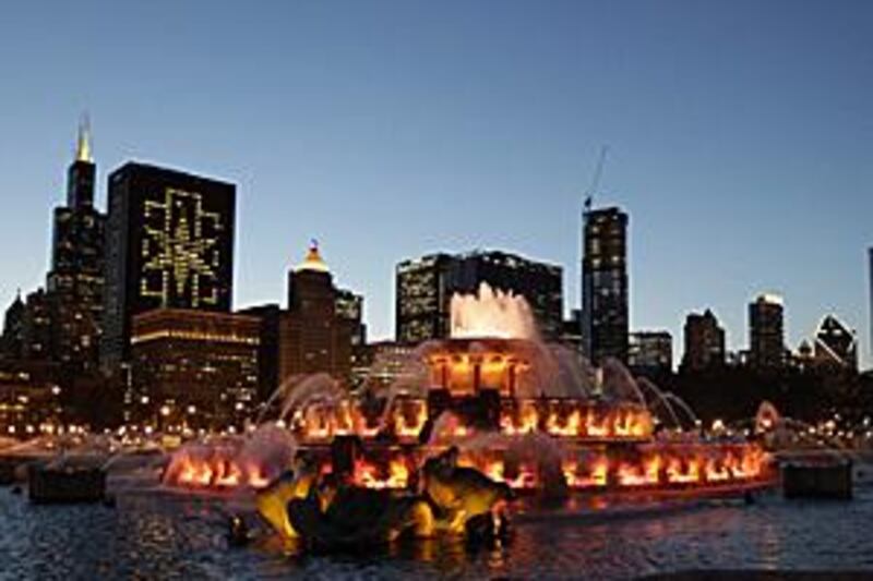 A Chicago 2016 emblem appears in lights of a high-rise building left, as the newly refurbished Buckingham Fountain welcomes the IOC's inspection committee on Tuesday.