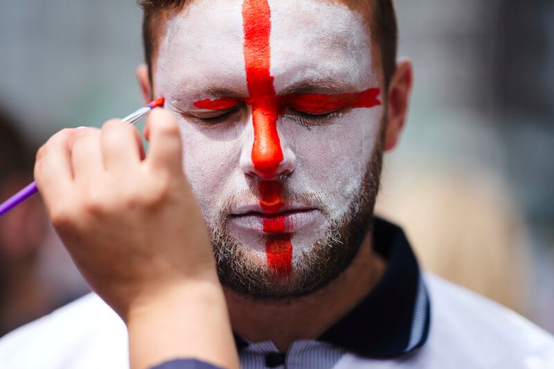 An England fan gets his face painted ahead of his team's match against Slovakia at the Euro 2024 football tournament in Gelsenkirchen, Germany. AP 
