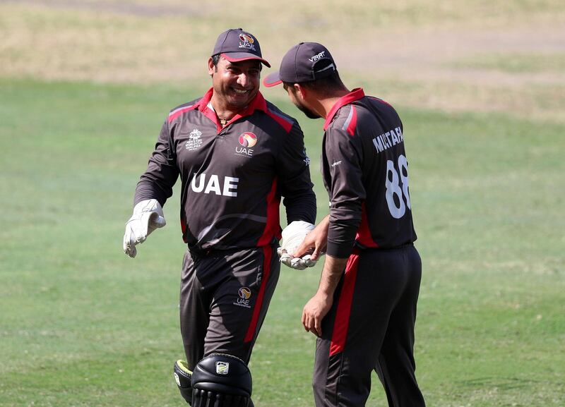 Dubai, United Arab Emirates - October 30, 2019: Muhammad Boota and Rohan Mustafa (R)of the UAE share a joke during the game between the UAE and Scotland in the World Cup Qualifier in the Dubai International Cricket Stadium. Wednesday the 30th of October 2019. Sports City, Dubai. Chris Whiteoak / The National
