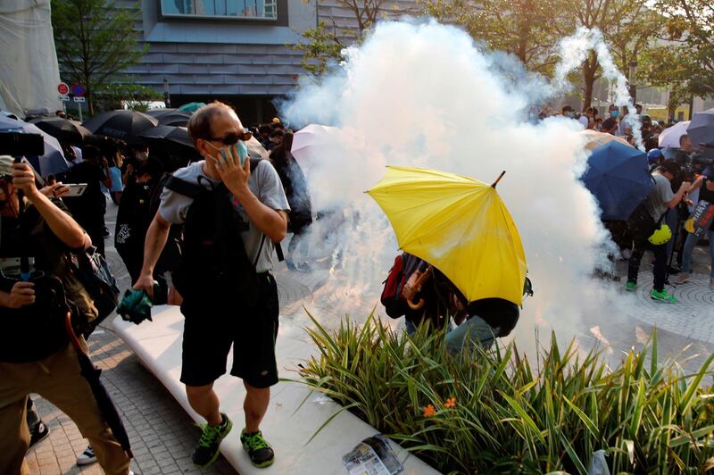 Anti-government protesters react from tear gas at Tsim Sha Tsui is in Hong Kong, China, October 27, 2019. REUTERS/Tyrone Siu