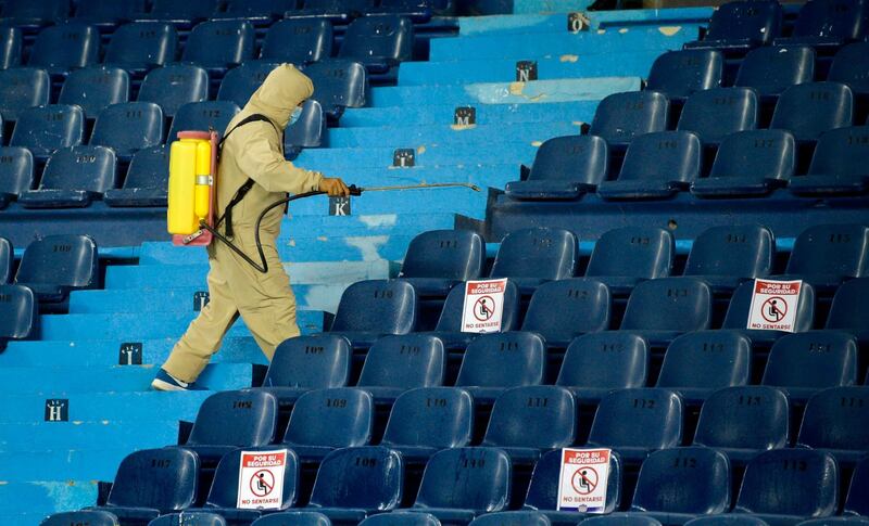 A worker disinfects the stands during the closed-door Copa Libertadores group phase football match between Colombia's Junior and Ecuador's Independiente del Valle, at the Roberto Melendez Stadium in Barranquilla, Colombia. AFP