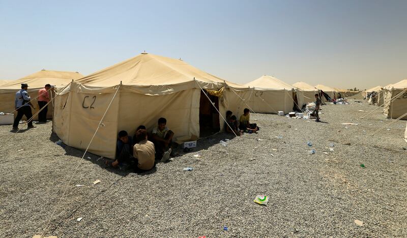 Families and relatives of men accused of being Islamic State militants are seen at a camp in Bartella, east of Mosul, Iraq July 15, 2017. Picture taken July 15, 2017. REUTERS/Thaier Al-Sudani