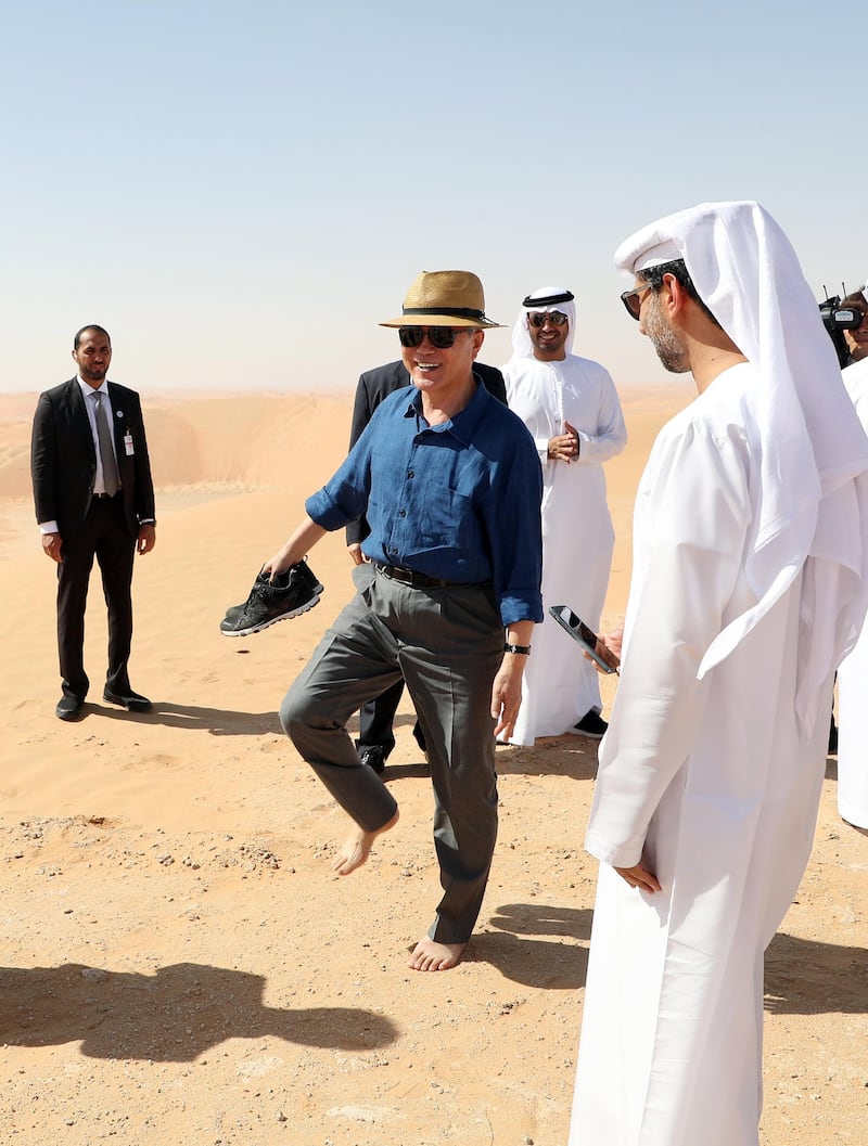 South Korean President Moon Jae-in goes barefoot as he walks on desert sand at a resort near Abu Dhabi. The brief trip 170 km from Abu Dhabi was arranged impromptu by the Crown Prince of Abu Dhabi, Sheikh Mohammed bin Zayed, who was told of Moon's wish to experience the desert and provided helicopters and vehicles. EPA /Yonhap news agency