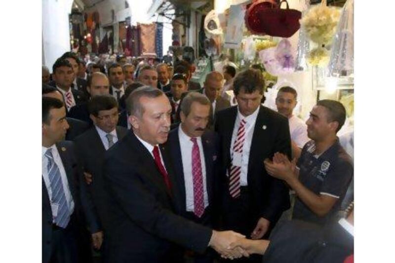 Turkish prime minister Recep Tayyip Erdogan tours the souk market in Tunis yesterday as part of a two-day visit to Tunisia. Hamine Landoulsi / AP Photo